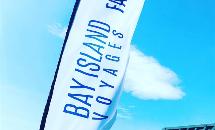 Bay Island Voyages flag flying in the wind